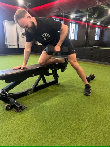 Lee Culbert demonstrating a supported dumbbell row in the gym